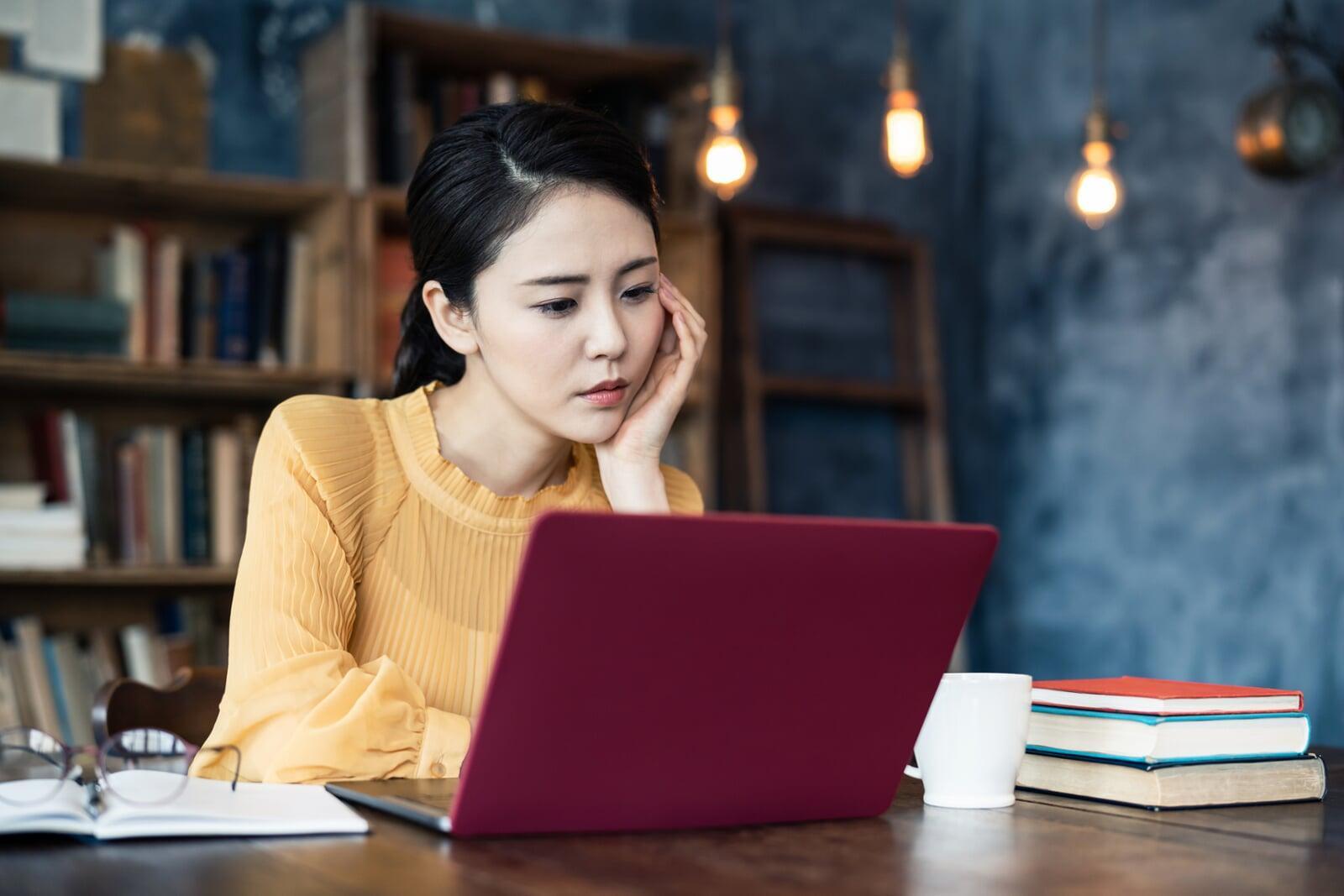 a lady using a laptop at a desk