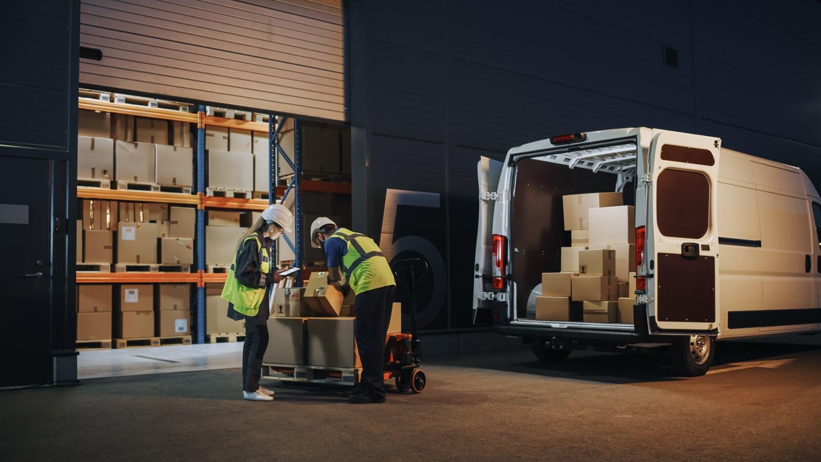 A van delivering boxes to a warehouse